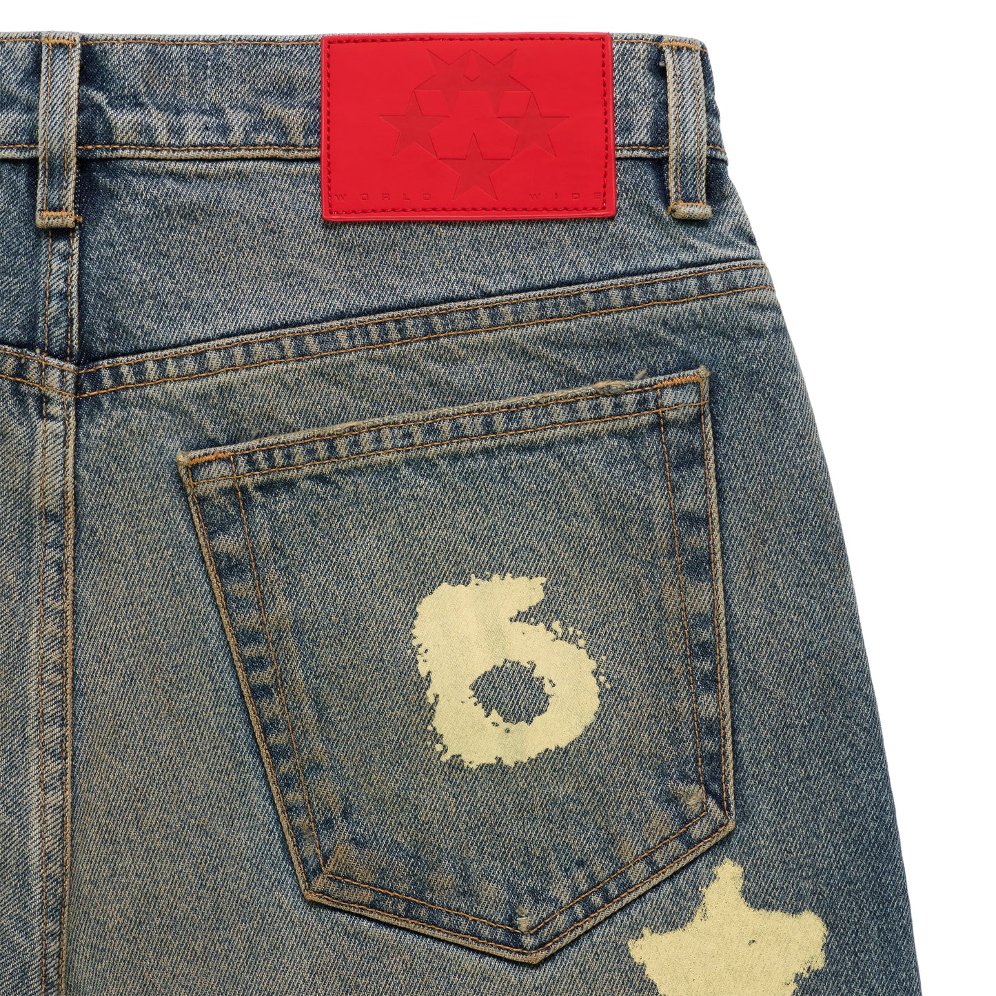 BELUGA STAMP DENIM jeans with a red branded leather back patch and a distressed "6" design on the back pocket.