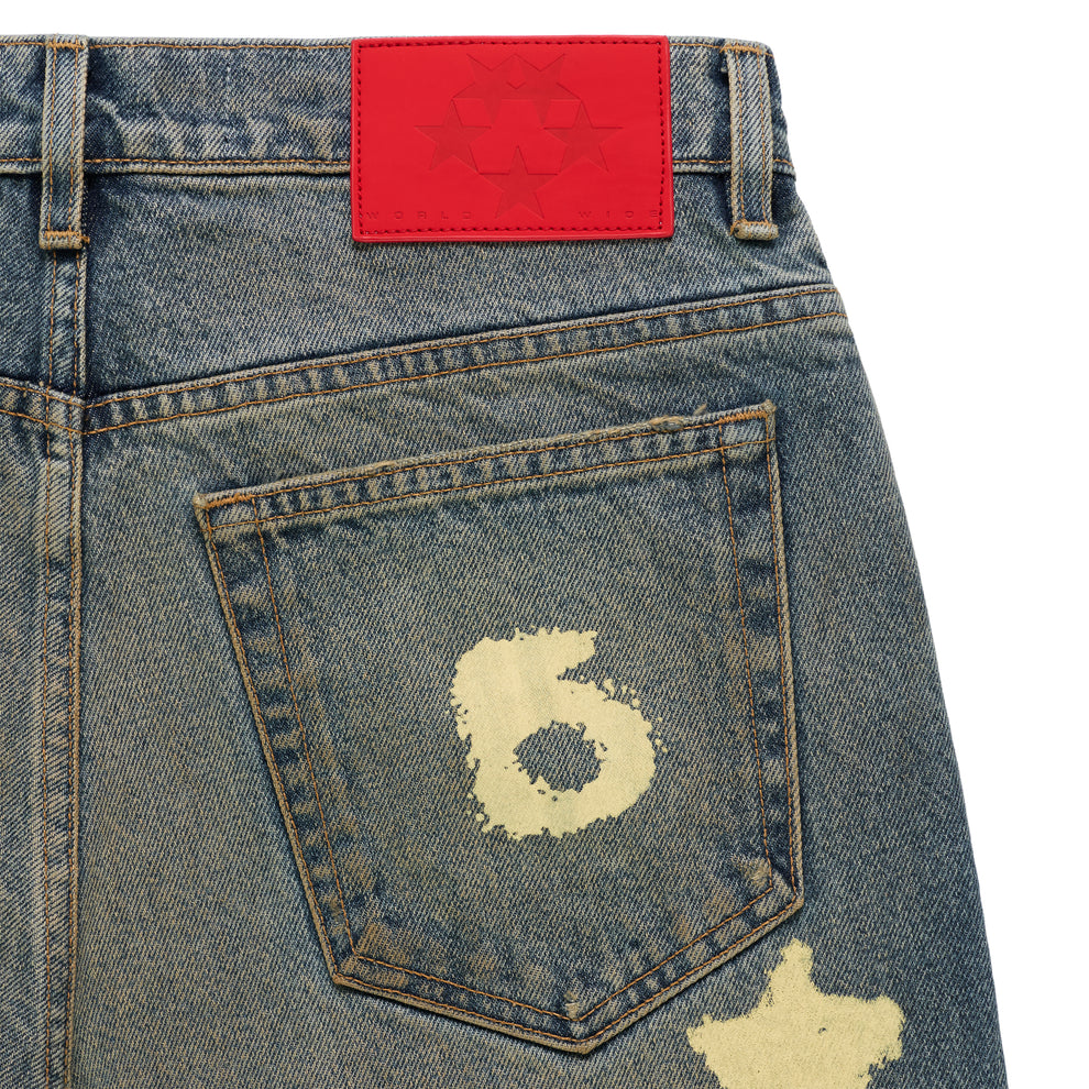 BELUGA STAMP DENIM jeans with a red branded leather back patch and a distressed "6" design on the back pocket.