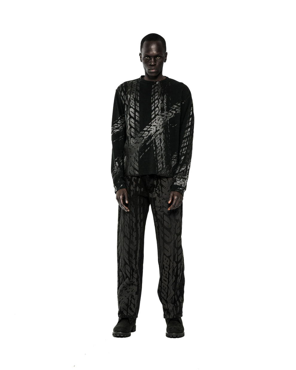 Black waffle knit thermal shirt and pants with all-over tire track print.