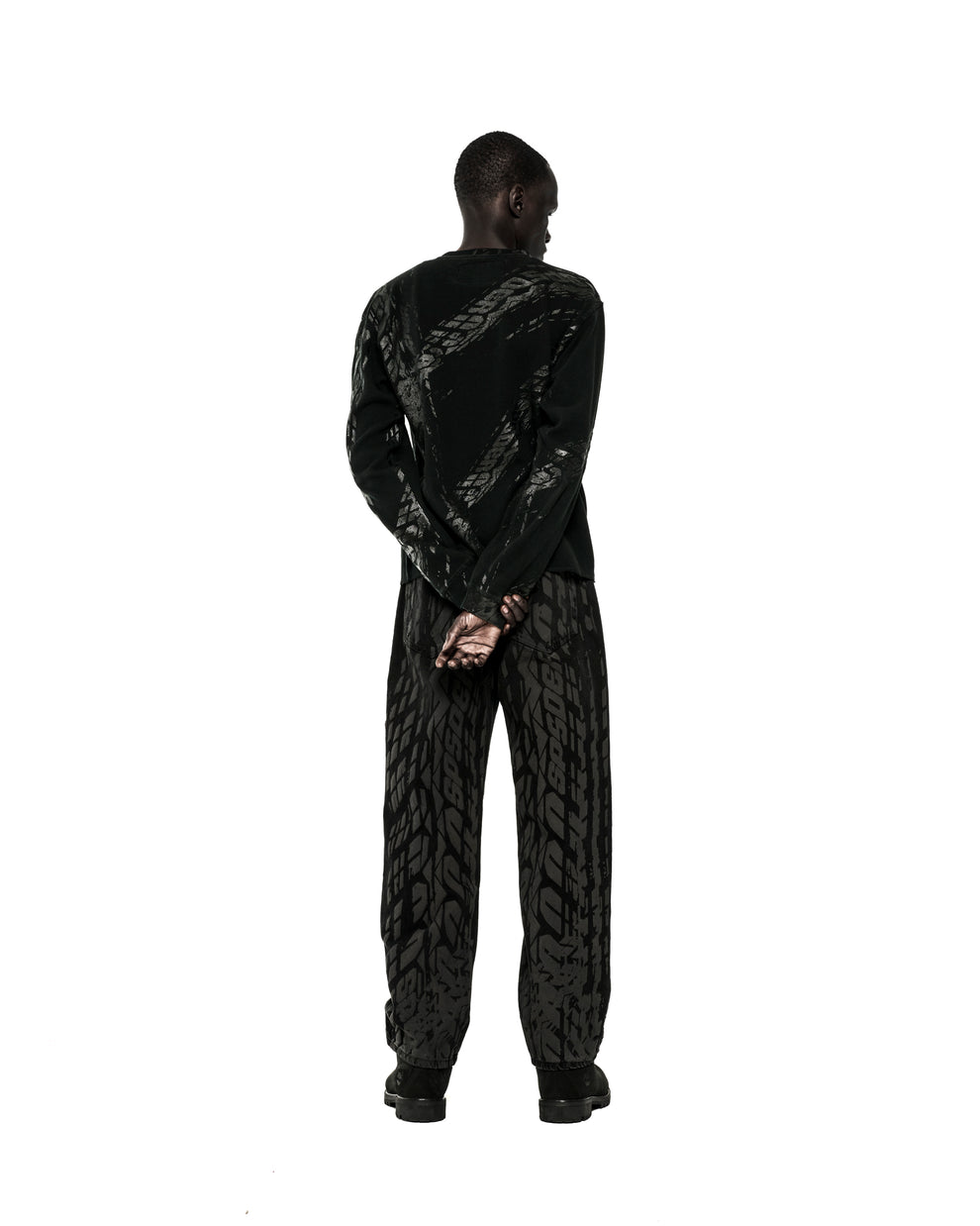 Black waffle knit thermal with tire track print, ribbed collar, hem, and cuffs.