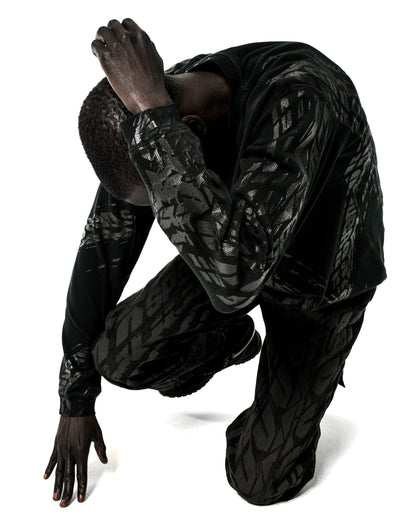 Black waffle knit thermal shirt and pants with all-over tire track print.