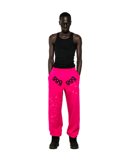 Model in hot pink ANGEL NUMBER SWEATPANTS with black '555' puff print and scattered stars.