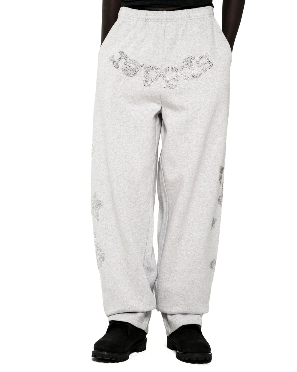 Light grey wide-leg sweatpants with rhinestone "SP5DER" text at crotch and "5" and star designs.