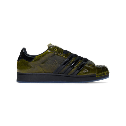 SP5DER x Adidas Superstar in glossy cracked olive patent leather with black stripes and translucent outsole.