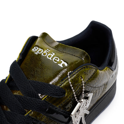 SP5DER x ADIDAS SUPERSTAR in olive green cracked patent leather with black laces and a silver spider charm.