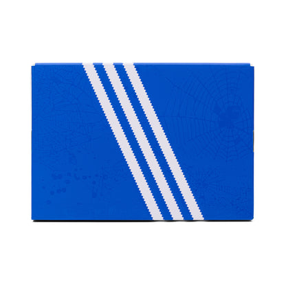 Blue SP5DER x ADIDAS SUPERSTAR shoebox with white stripes and subtle spiderweb graphics.