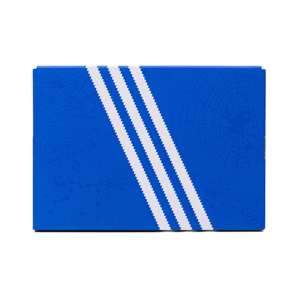 Blue SP5DER x ADIDAS SUPERSTAR shoebox with white stripes and subtle spiderweb graphics.