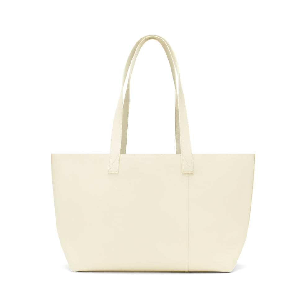 Cream genuine leather tote bag with embossed logo, dual shoulder straps, and structured silhouette.