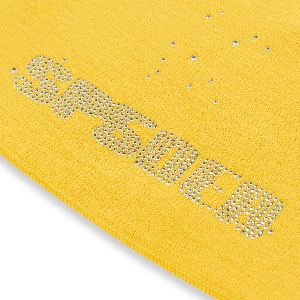 Yellow acrylic skully with "SP5DER" in silver rhinestones and scattered rhinestones.