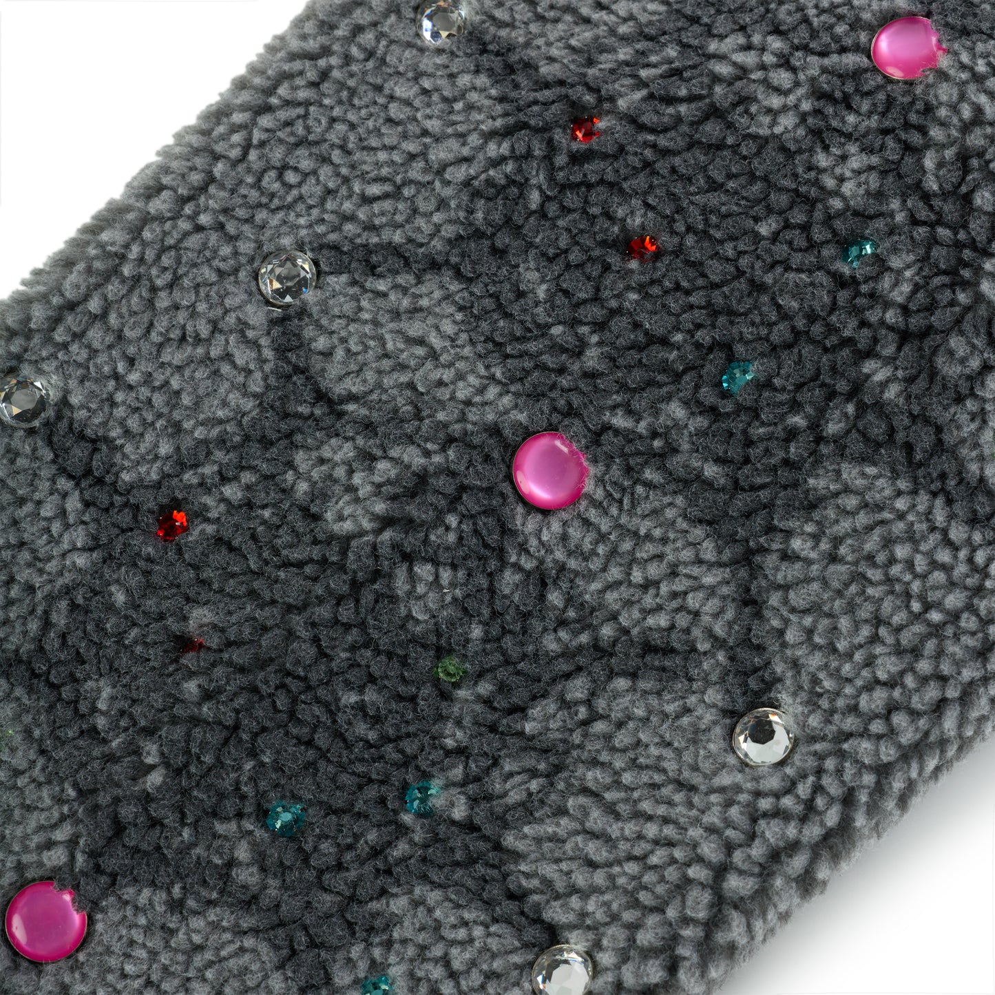 Close-up of gray sherpa fleece with scattered pink, clear, red, and teal rhinestone embellishments.
