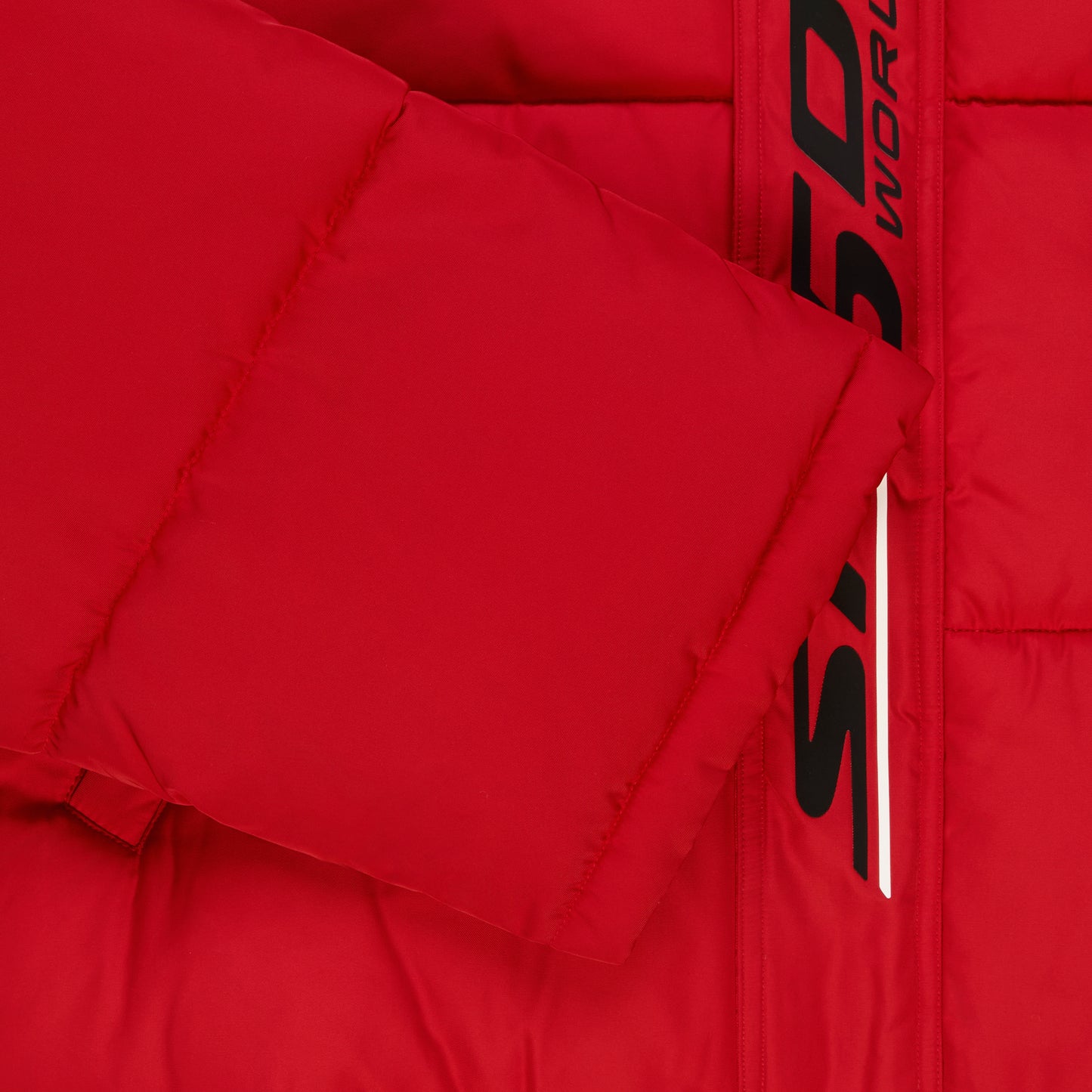 Red poly-fill puffer jacket with black reflective text graphic along the front placket.