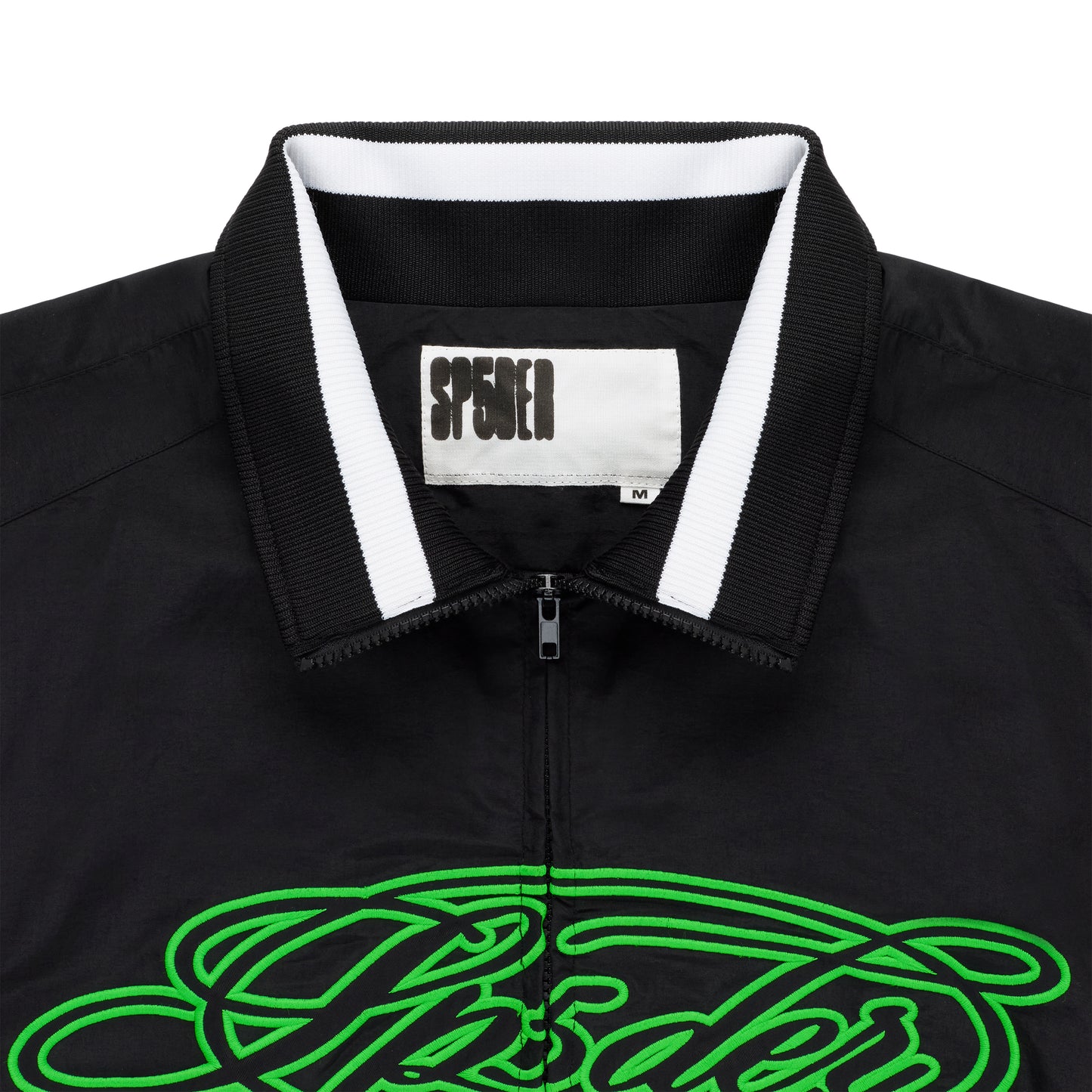 Black nylon track jacket with full zip, stand collar, white stripe detail, and green embroidered script logo.