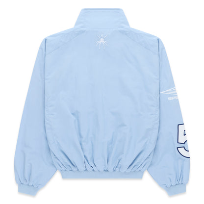 Light blue nylon track jacket, back view, with white spider logo on upper back and white sleeve graphic.