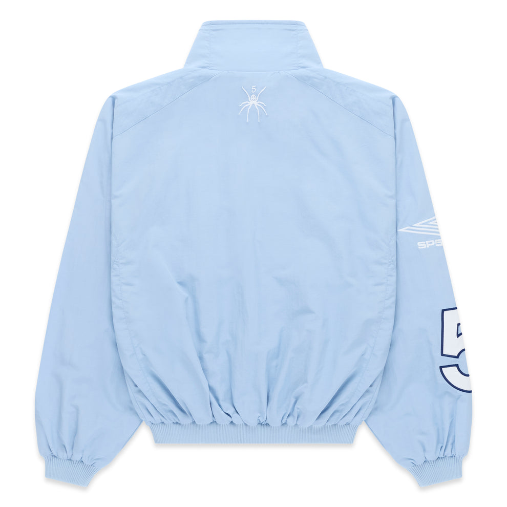 Light blue nylon track jacket, back view, with white spider logo on upper back and white sleeve graphic.
