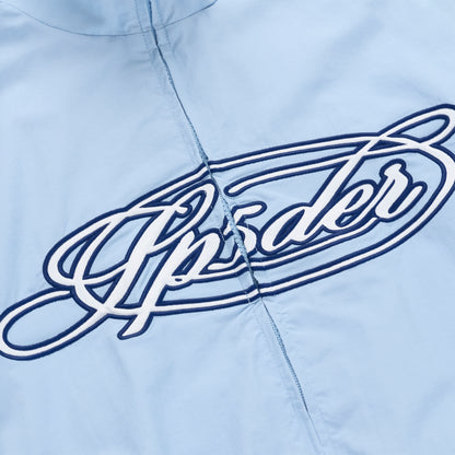 Light blue nylon track jacket with a white and navy embroidered "Upsider" script logo on the chest.