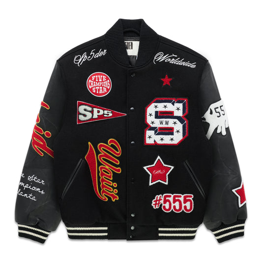 Black wool varsity jacket with leather sleeves, debossed web design, and multiple embroidered patches.