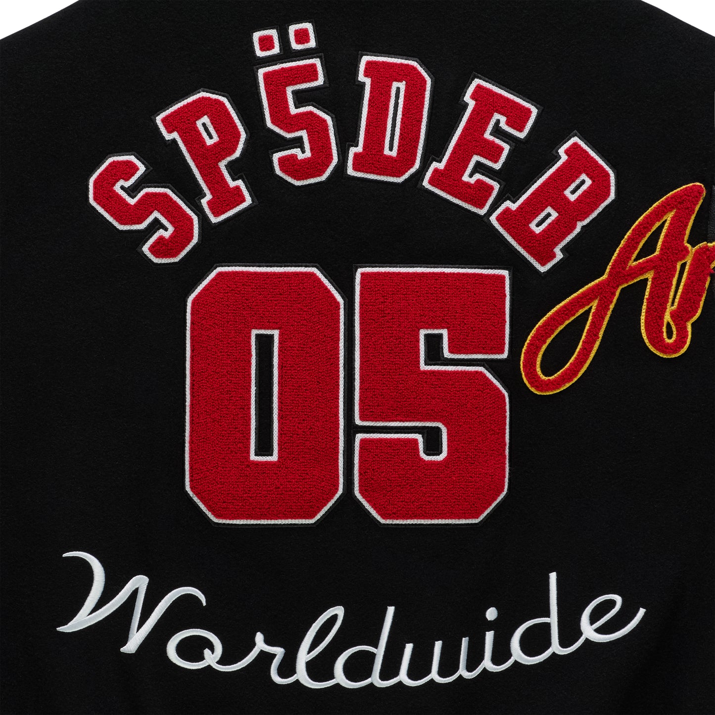 Black varsity jacket with red "SP5DER 05" and white "Worldwide" embroidered patches.