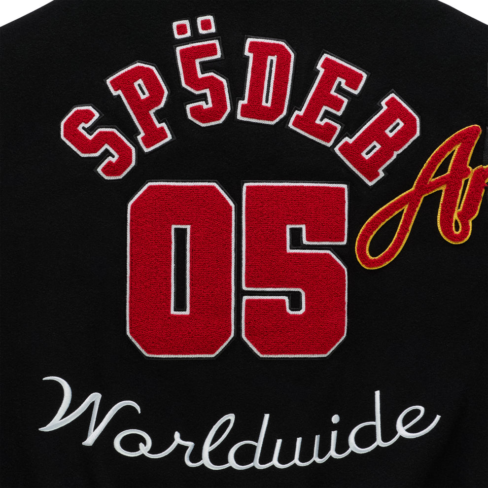 Black varsity jacket with red "SP5DER 05" and white "Worldwide" embroidered patches.