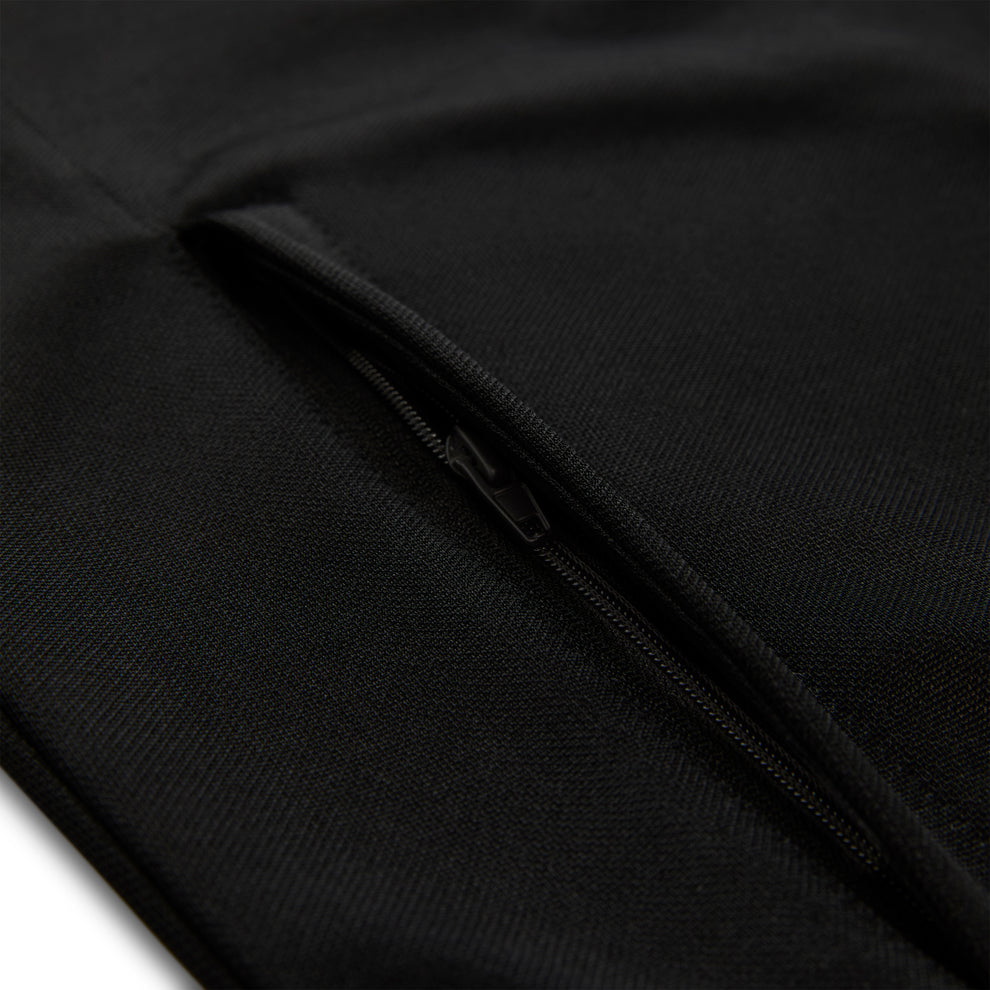 Close-up of a black athletic polyester track jacket with a zippered side pocket.