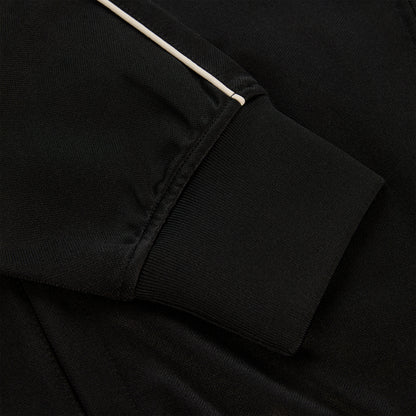 Black polyester Atlanta Track Jacket sleeve with white piping and ribbed cuff.