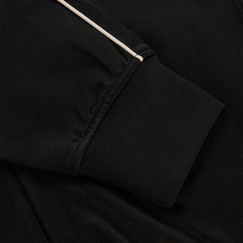 Black polyester Atlanta Track Jacket sleeve with white piping and ribbed cuff.