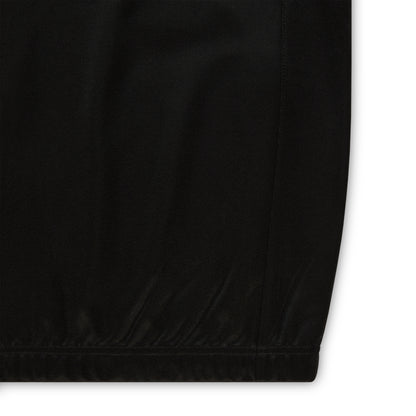 Black athletic polyester fabric with subtle texture, hem, and side seam.