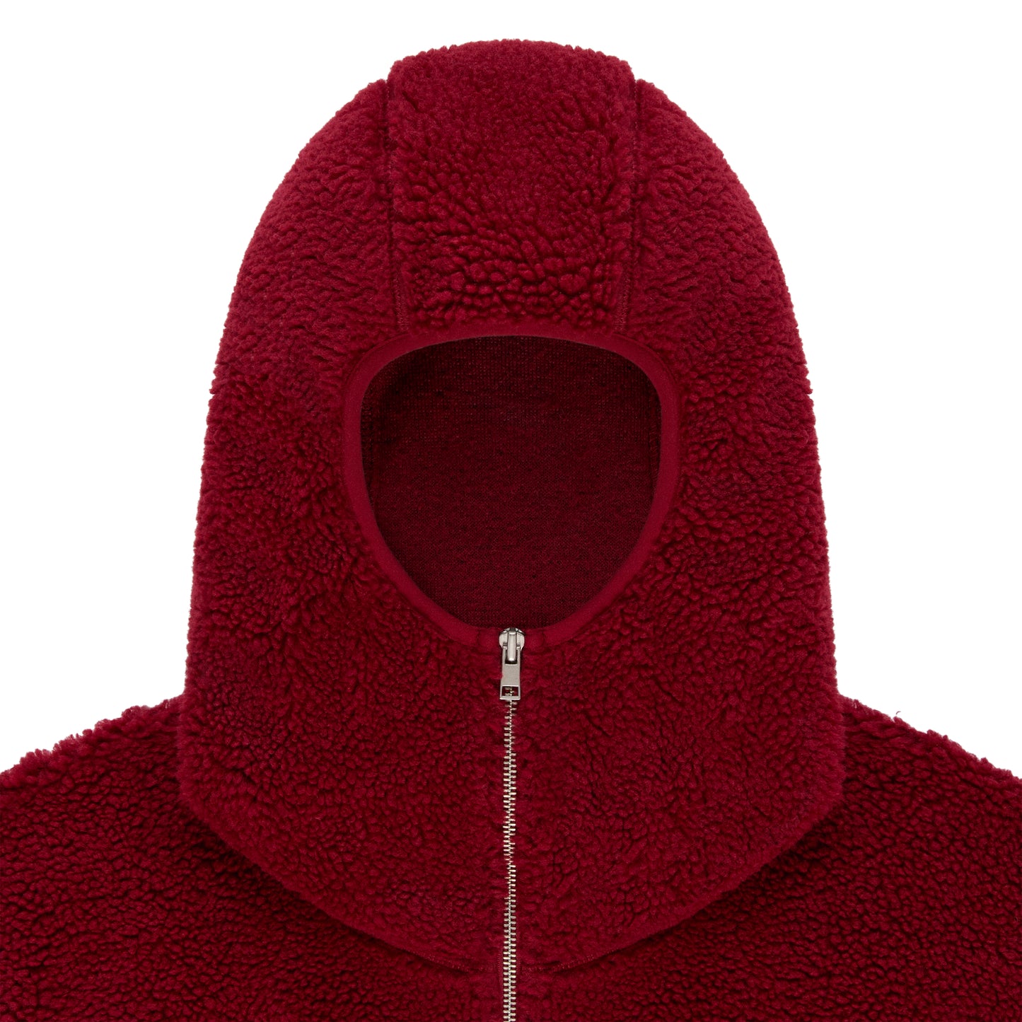 Close-up of a red sherpa fleece hooded jacket with a narrow front opening and silver zip closure.