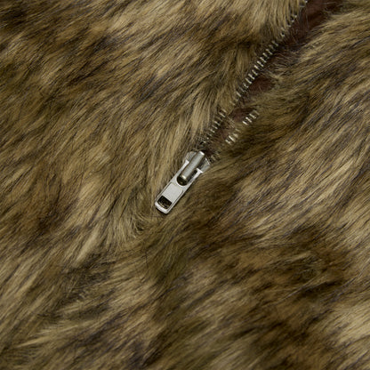 Close-up of a brown faux fur jacket with a silver zipper partially open.