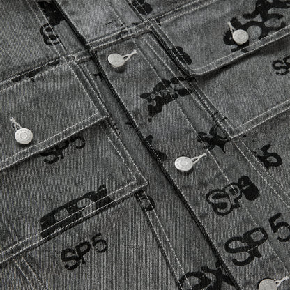 Gray denim trucker jacket with all-over black foil print, silver buttons, and red contrast stitching.
