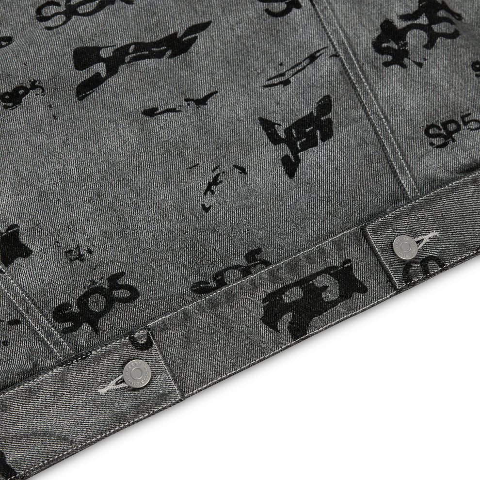 Gray denim trucker jacket with all-over black foil print and silver button closures.