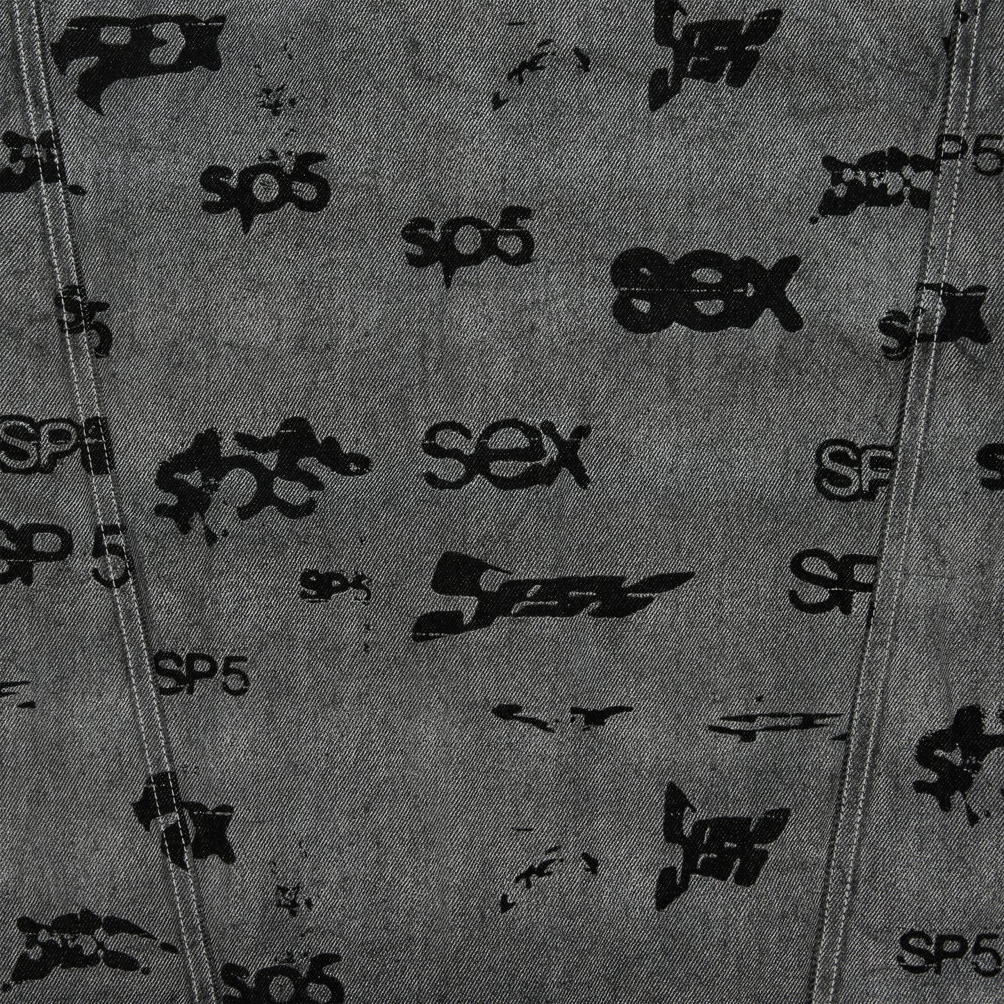 Gray denim trucker jacket with black all-over print design and red contrast stitching.