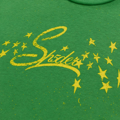 Green cotton/spandex tee with yellow "Shades" graphic and stars, cropped fitted style.