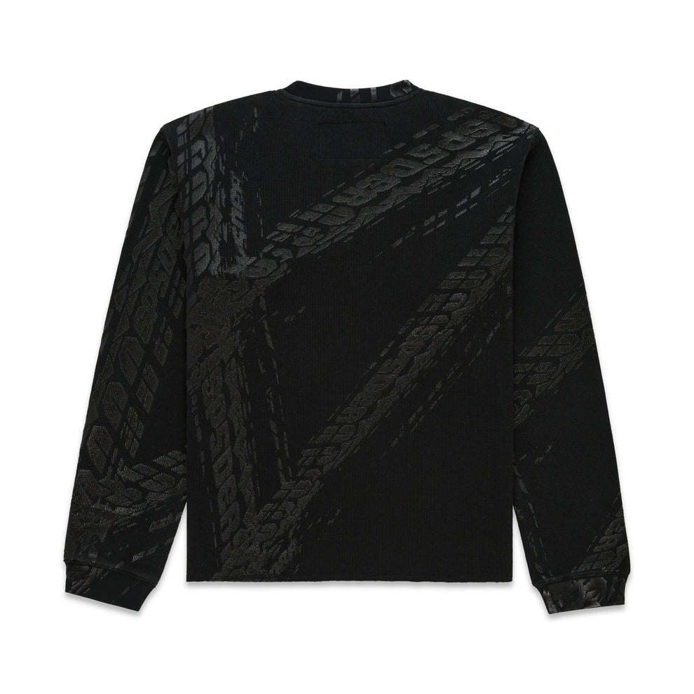 Black waffle knit thermal with ribbed collar, hem, cuffs, and all-over tire track print.