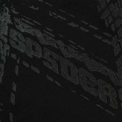 Close-up of black waffle knit thermal with subtle tire track print.