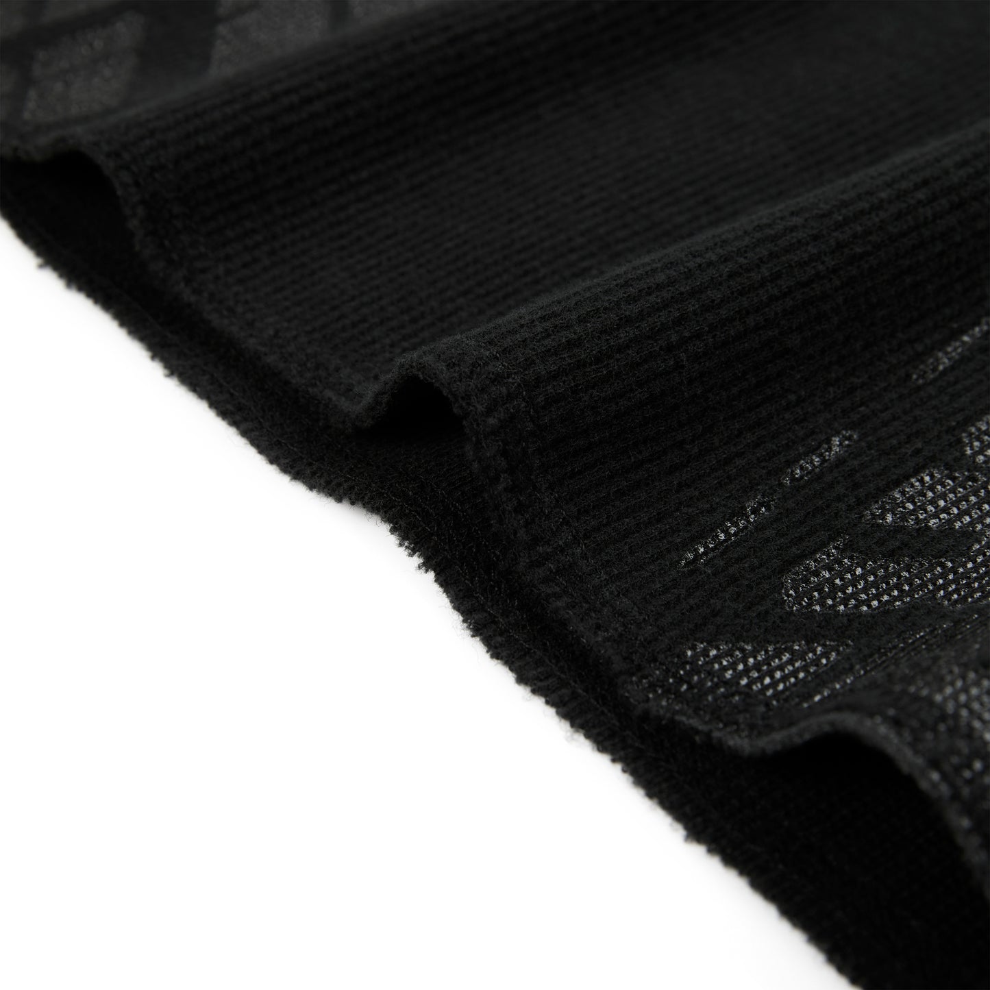 Black waffle knit thermal with ribbed details and subtle tire track print.