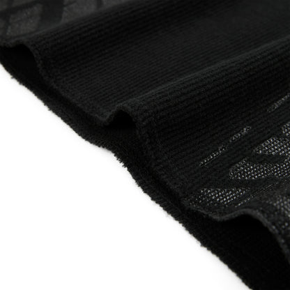 Black waffle knit thermal with ribbed details and subtle tire track print.