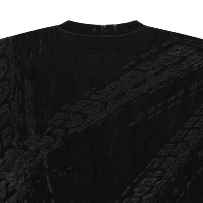 Black waffle knit thermal with ribbed collar and subtle tire track print.