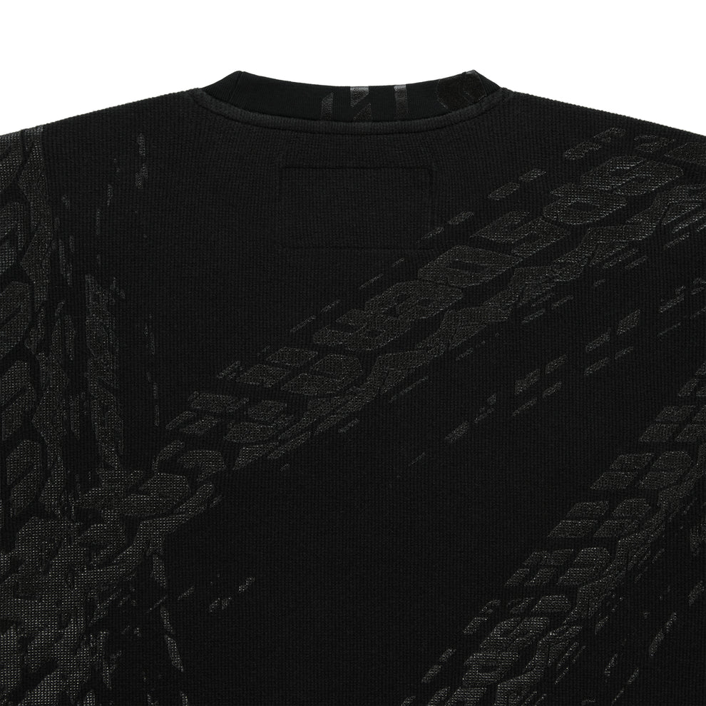 Black waffle knit thermal with ribbed collar and subtle tire track print.