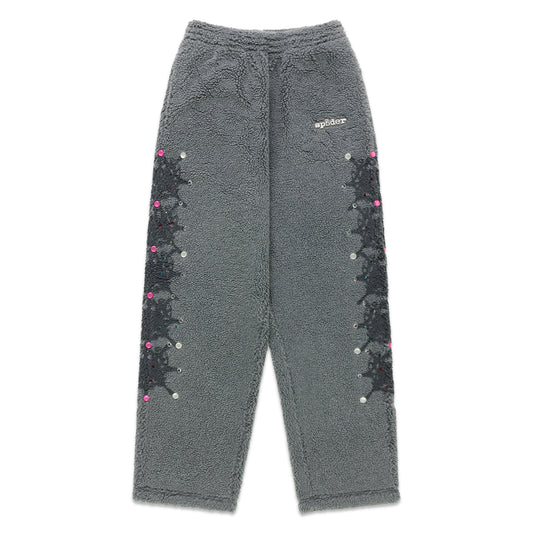 Gray sherpa fleece pants with rubberized logo, web print, and rhinestone embellishments down both legs.