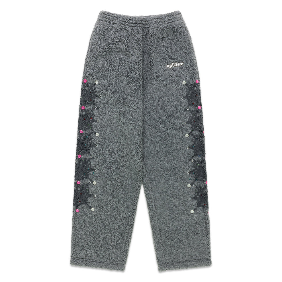 Gray sherpa fleece pants with rubberized logo, web print, and rhinestone embellishments down both legs.