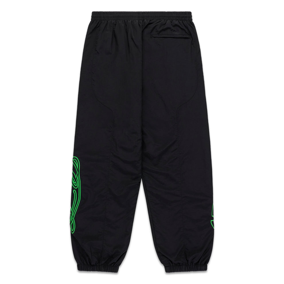 Black nylon SCRIPT WARM UP PANT with green embroidered graphic, elastic cuffs, and paneled construction.