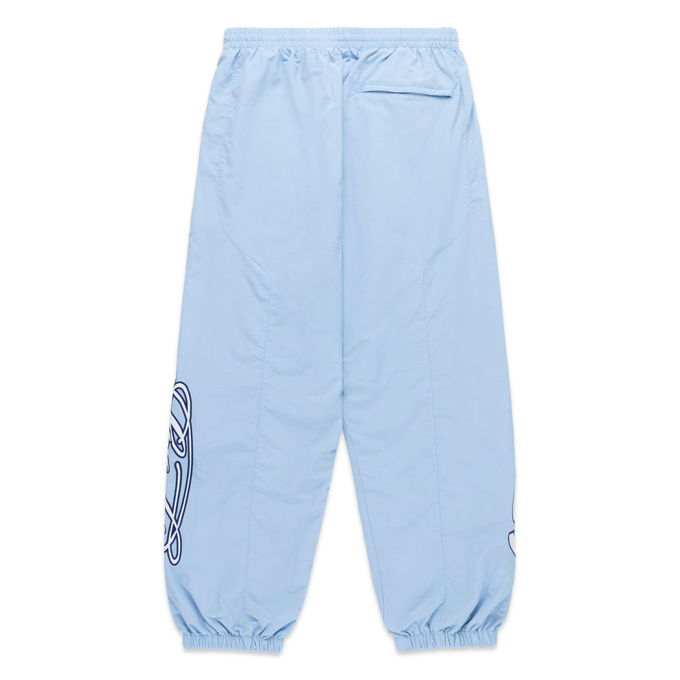 Light blue nylon track pants with paneled construction, elasticized cuffs, and embroidered graphic detailing.