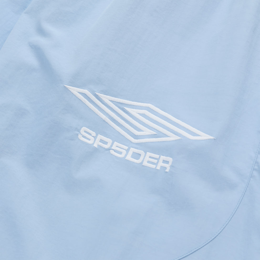 Light blue nylon track pant with white embroidered SP5DER logo and graphic.