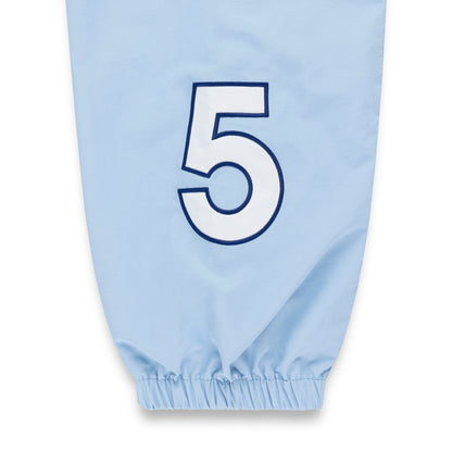 Light blue nylon track pant with white number 5 graphic and elastic cuff.