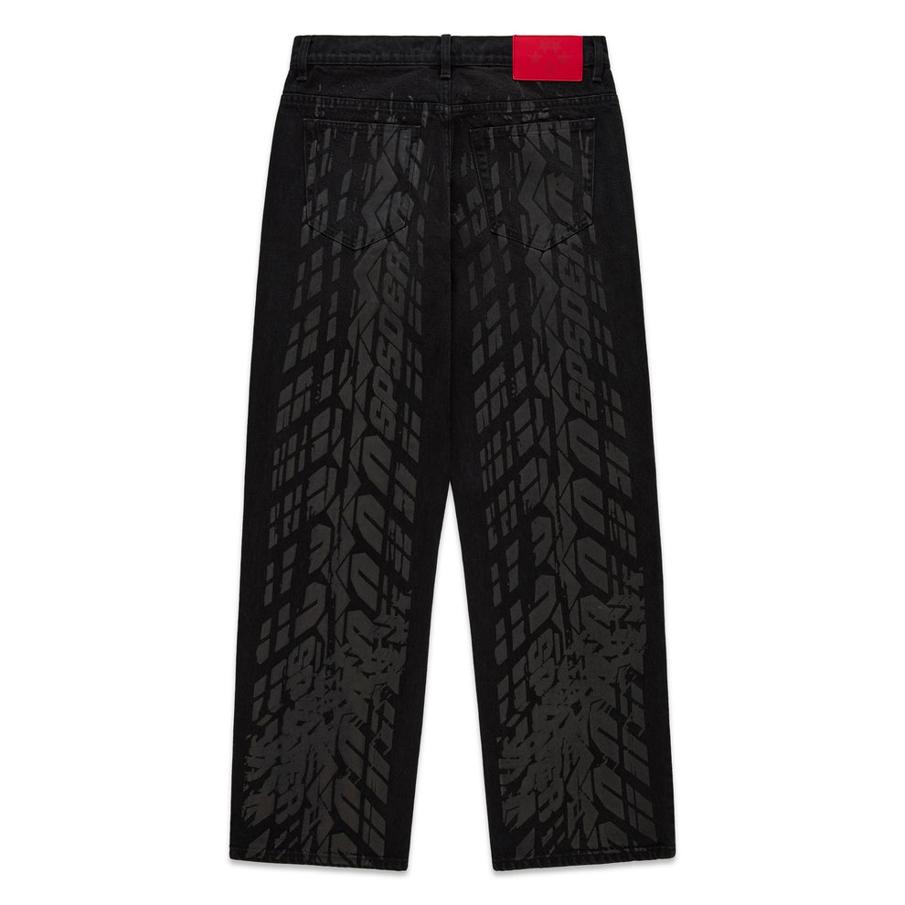 Black denim pants with all-over tire track design, branded leather back patch, and straight leg fit.