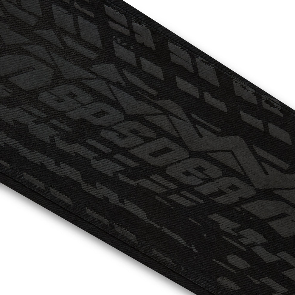 Black denim pant with all-over dark gray tire track design.