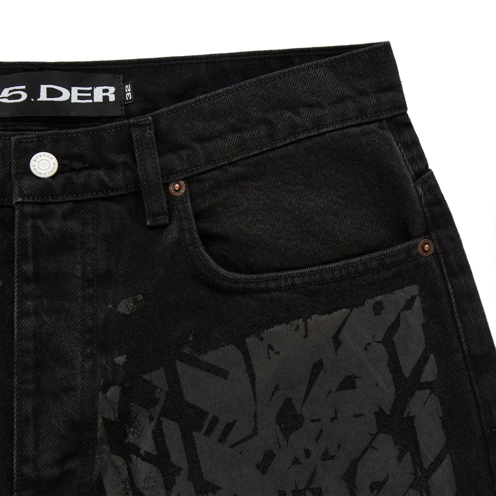 Black denim pants with all-over tire track design, custom hardware, and belt loops.
