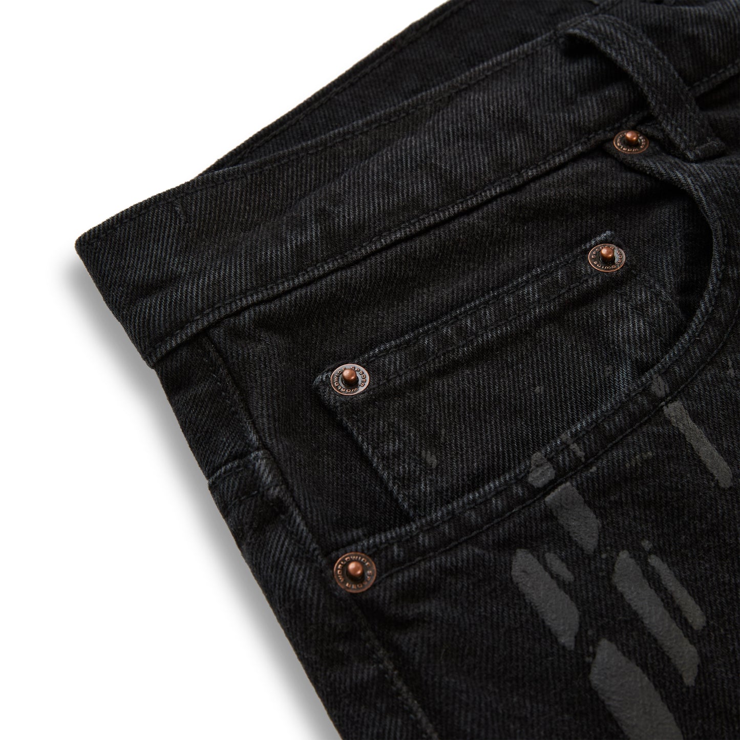 Black denim pants with all-over tire track design and custom branded copper hardware.