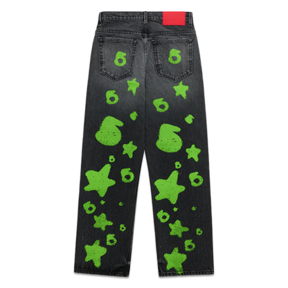Faded black denim pants with bright green Beluga stamp and star designs, red back patch.