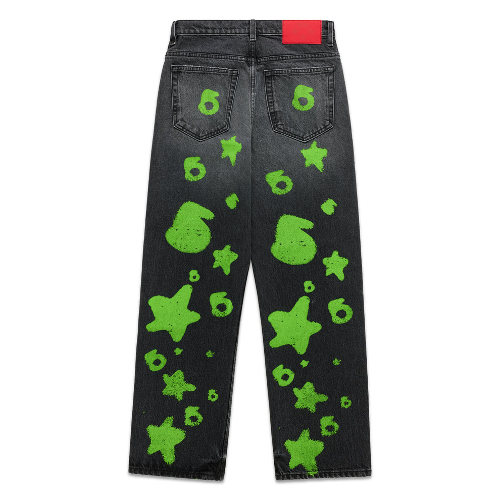 Faded black denim pants with bright green Beluga stamp and star designs, red back patch.